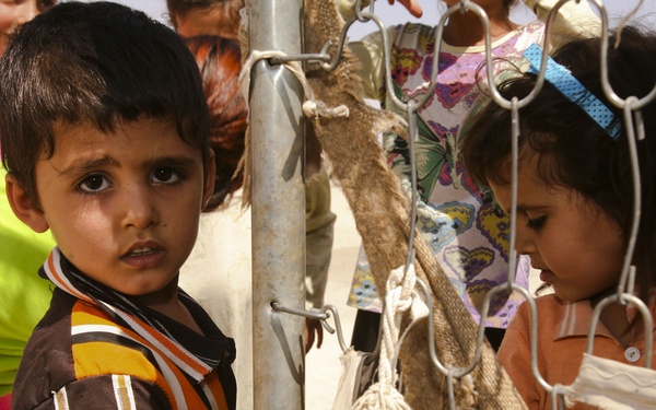 Iraqi Children Wait in Line During Iraqi Women's Engagement