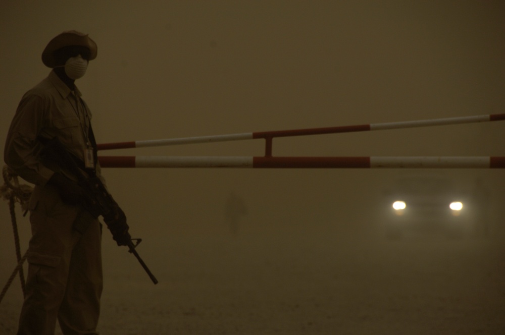 Ugandan Guard Stands Ready During Sandstorm