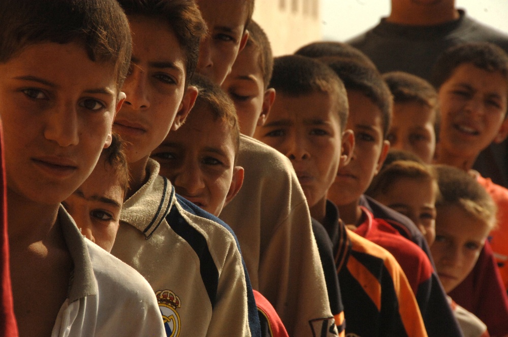 Iraqi Children Wait in Line to Receive Free Book Bags