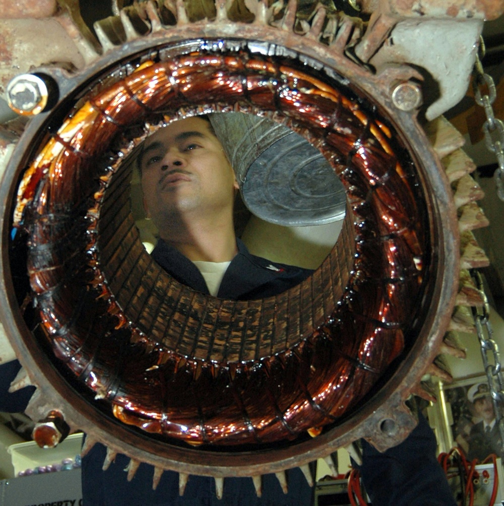 Sailors works on USS Kitty Hawk