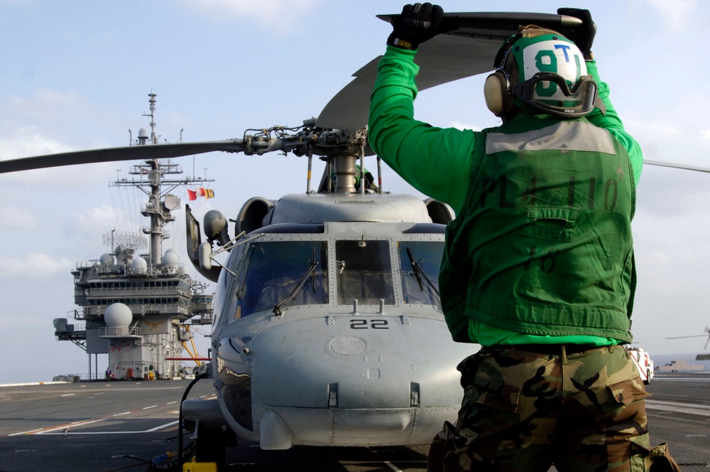 Sailors works on USS Kitty Hawk