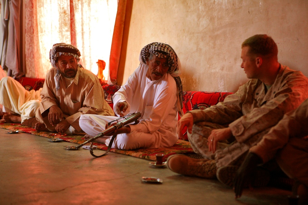An Iraqi Man Shows Marine His Wound