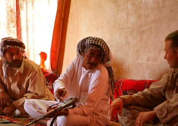 An Iraqi Man Shows Marine His Wound