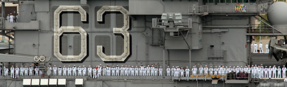 Standing proud aboard the USS Kitty Hawk