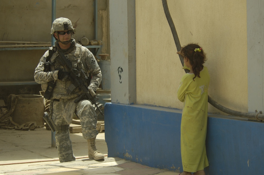 U.S. Soldier Entertains Iraqi Girl
