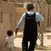 Iraqi Police Officer Escorts Small Child Home
