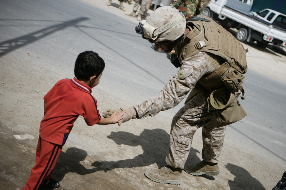 U.S. Marine Slaps Hands With Iraqi Boy