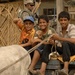 Iraqi Children Ride Past Guarding Soldiers