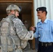 U.S. Soldier and Iraqi Policeman Happily Greet