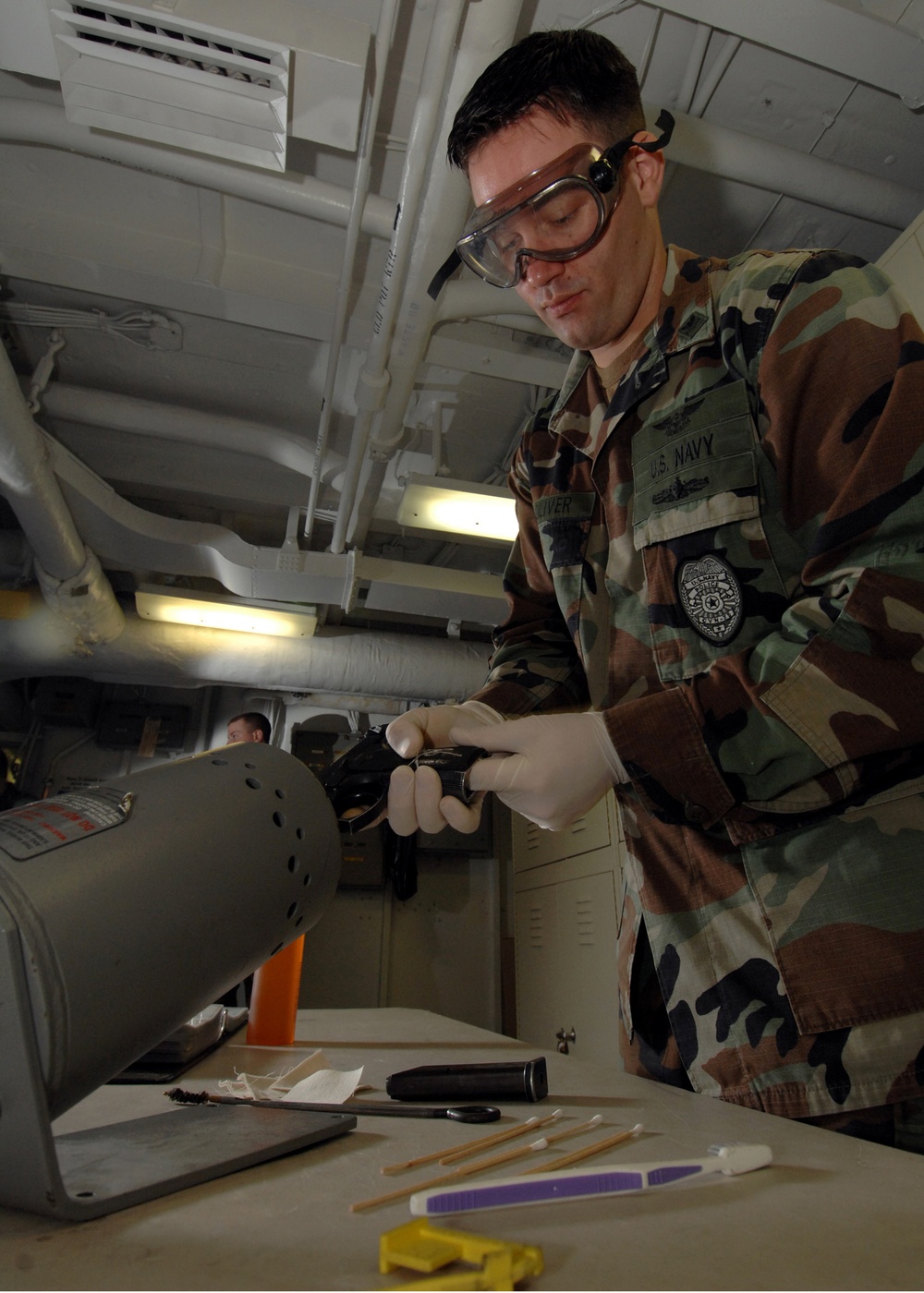 USS Harry S. Truman Sailor cleans pistol