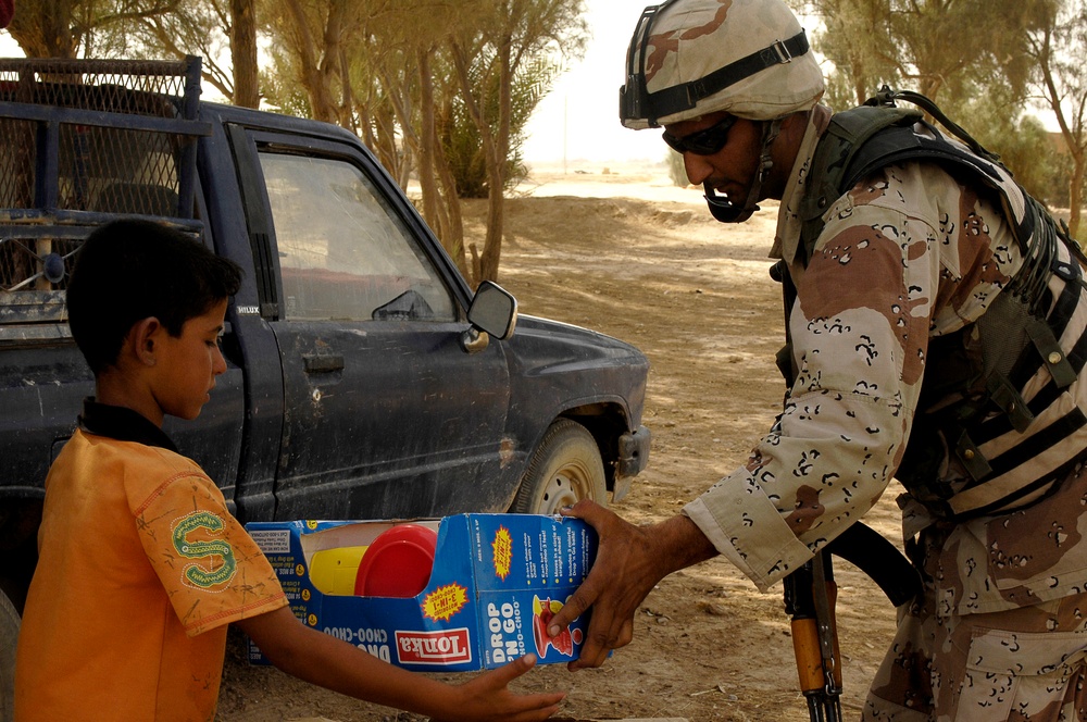 Iraqi Children Receive Toys From Iraqi Soldiers