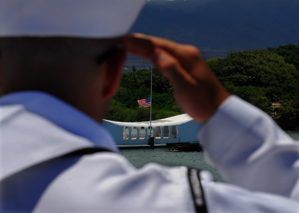 Sailors salute the USS Arizona Memorial