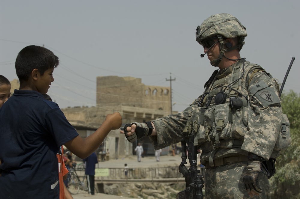 U.S. Soldier Makes Friends With Local Boy