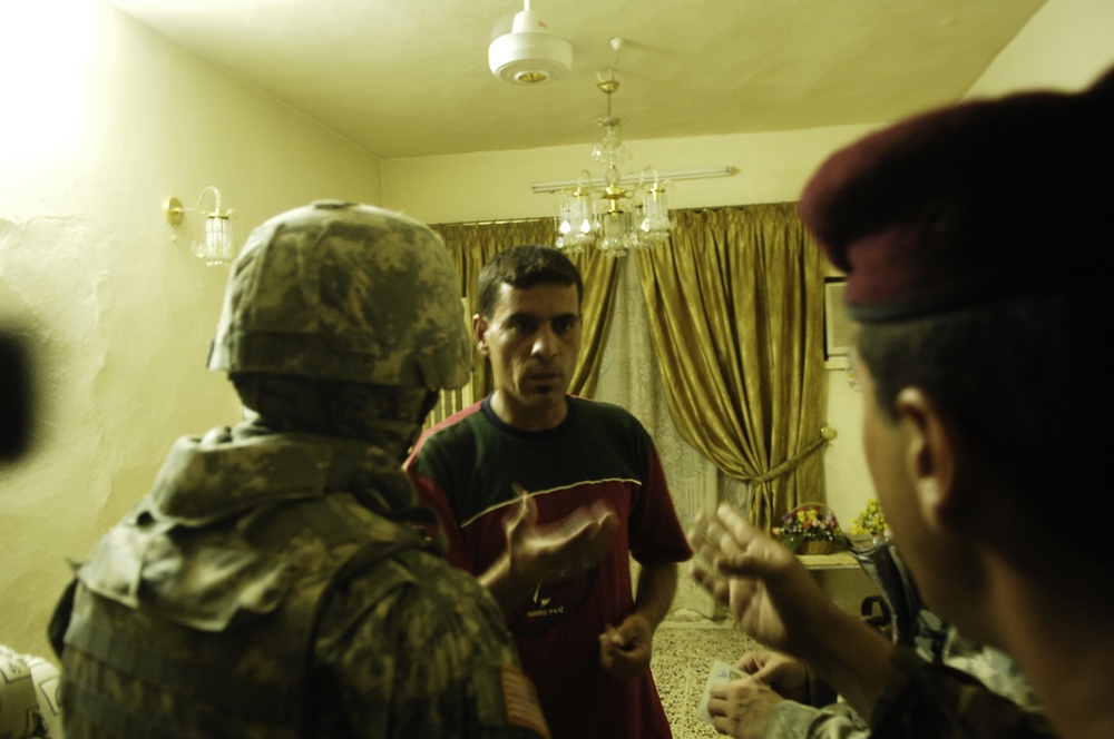 Iraqi and U.S. Soldiers Search for Weapon Cache