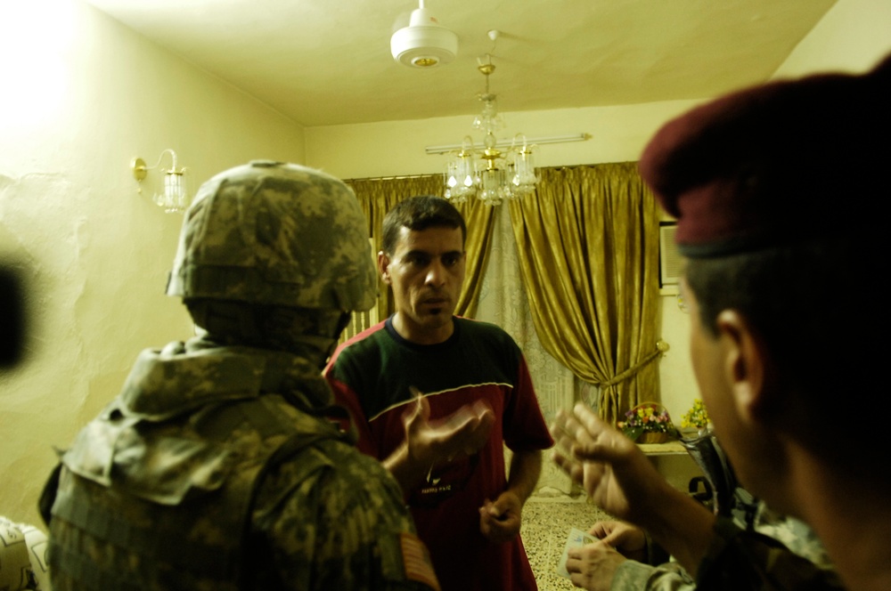 Iraqi and U.S. Soldiers Search for Weapons Cache