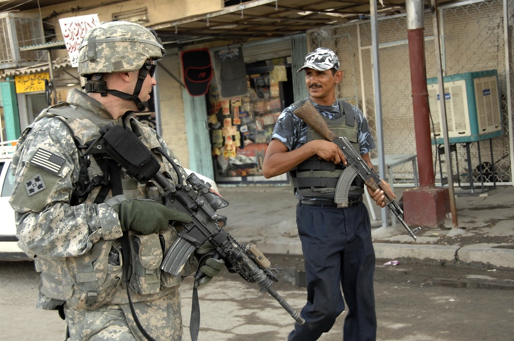 U.S, Iraqi soldiers Patrol Baghdad Neighborhood