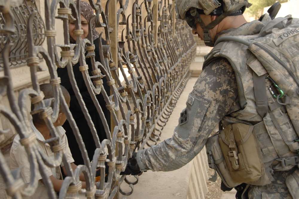 U.S, Iraqi soldiers Patrol Baghdad Neighborhood