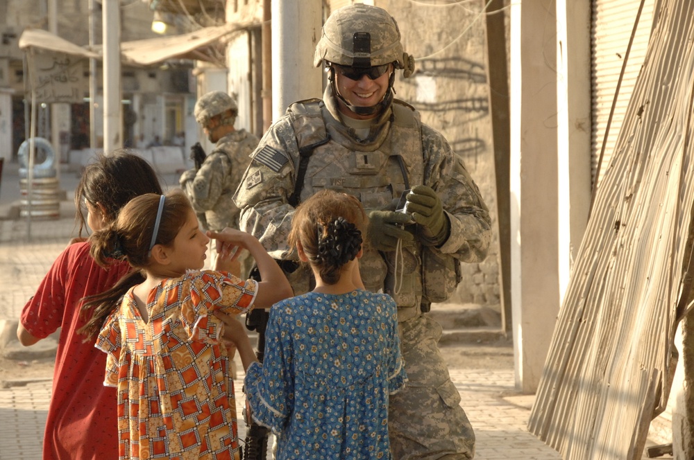 U.S, Iraqi soldiers Patrol Baghdad Neighborhood