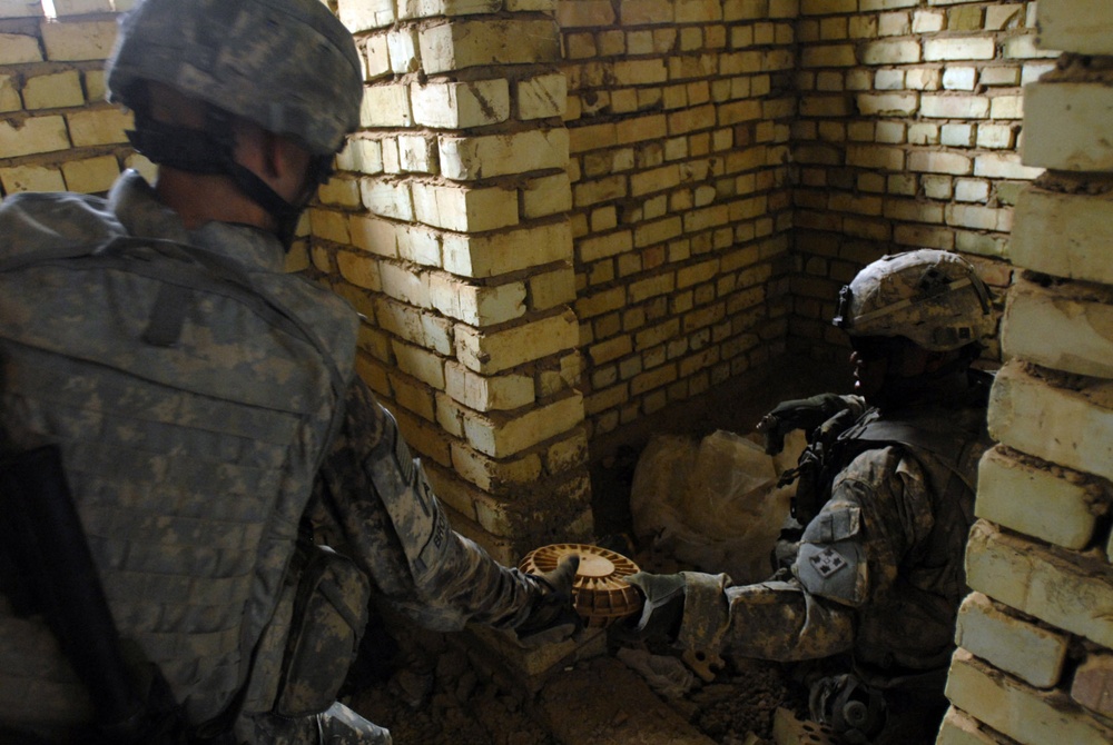 Soldiers from 1st Brigade Combat Team, 4th Infantry Division, discovers munitions cache in Abu T'shir