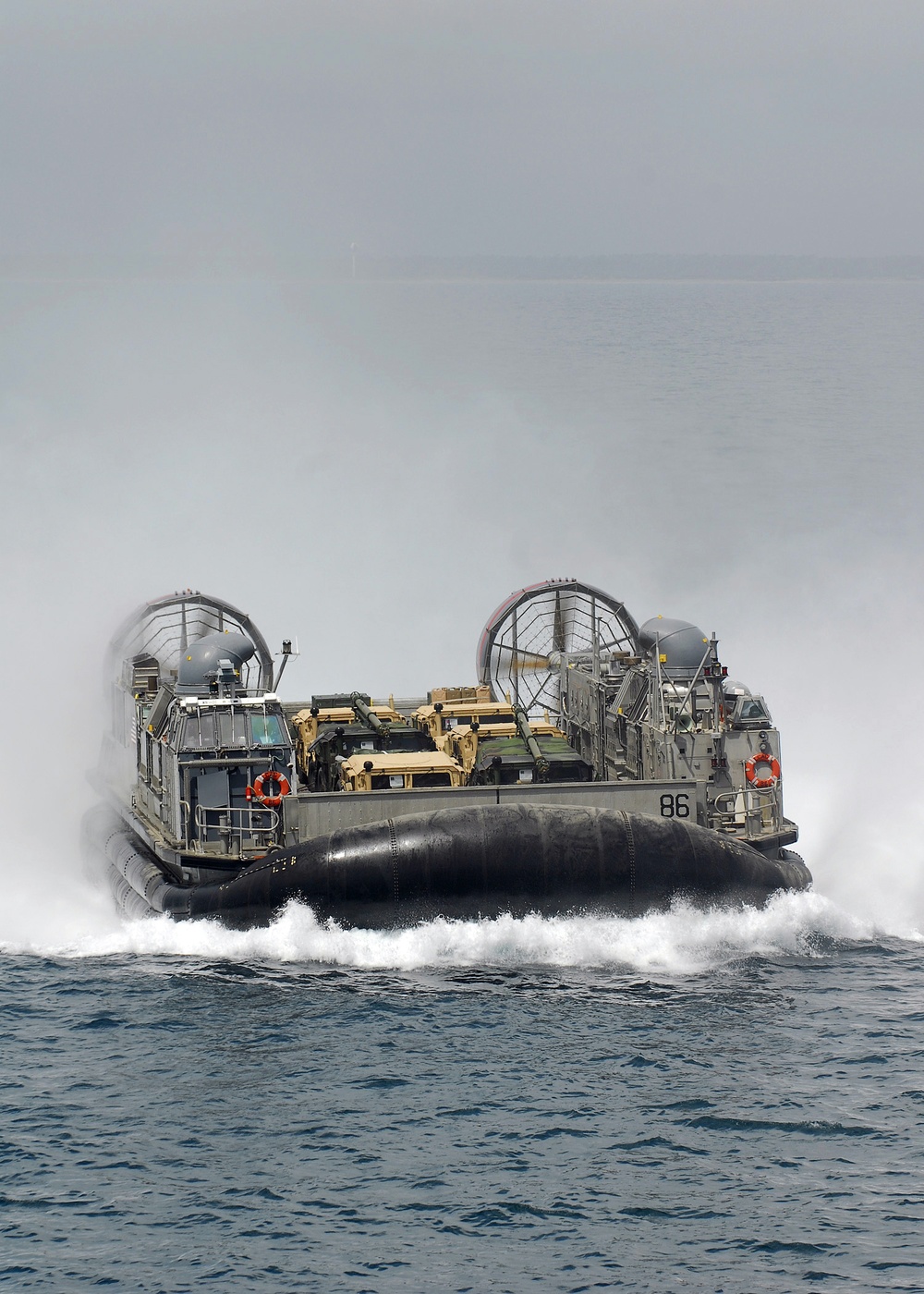 Landing craft air cushion approaches USS Iwo Jima