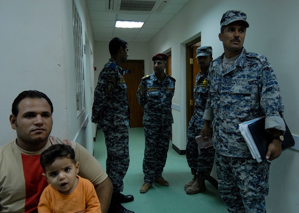 U.S. Soldiers, Iraqi Police Exam Iraqi Civilians