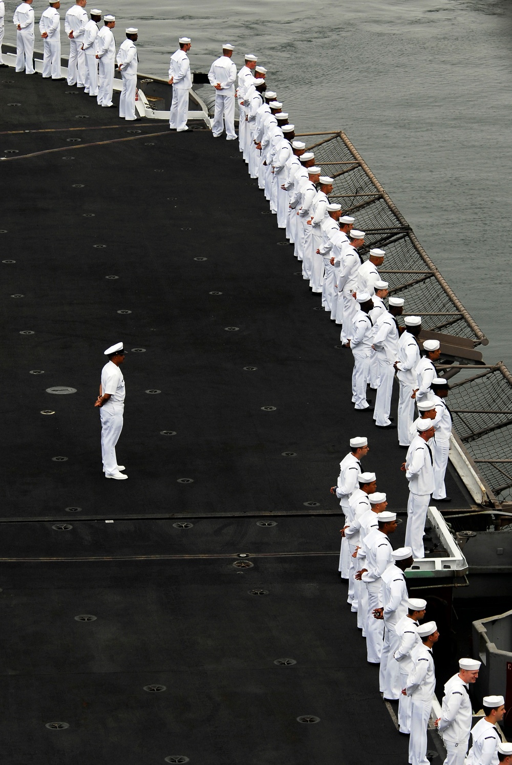 Sailors man rails as USS Kitty Hawk leaves San Diego
