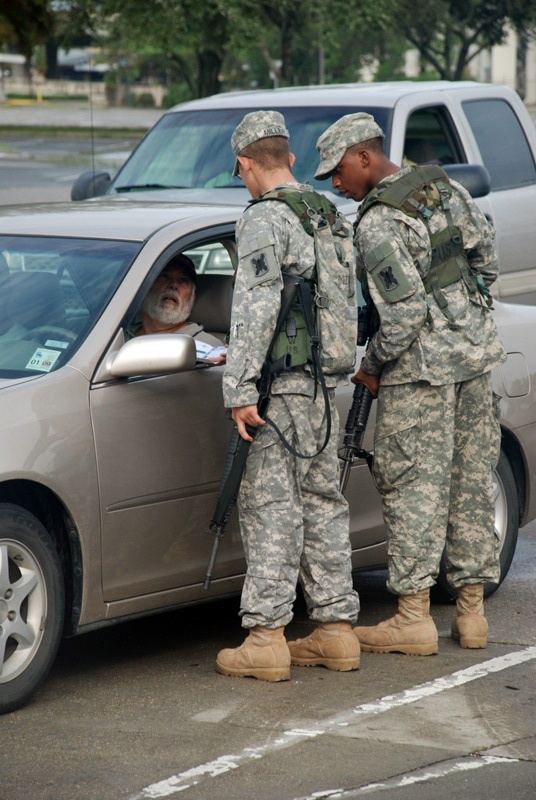 Members of the Louisiana National Guard's 256th Brigade Combat Team control traffic
