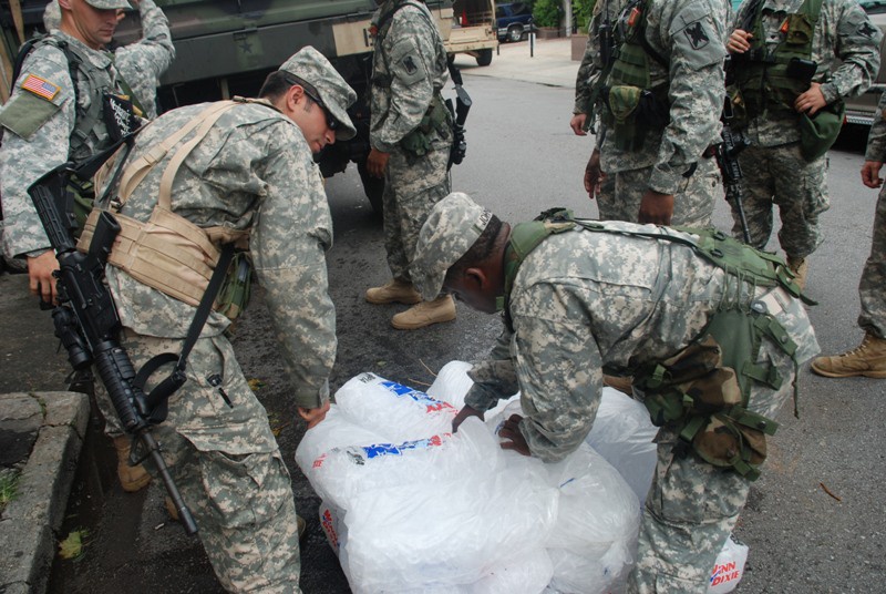 Members of the Louisiana National Guard's 256th Brigade Combat Team Distribute Supplies