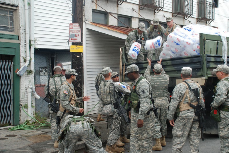 Members of the Louisiana National Guard's 256th Brigade Combat Team Distribute Supplies