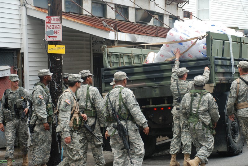 Members of the Louisiana National Guard's 256th Brigade Combat Team Distribute Supplies