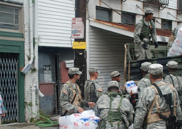 Members of the Louisiana National Guard's 256th Brigade Combat Team Distribute Supplies