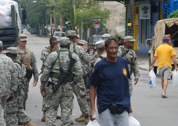Members of the Louisiana National Guard's 256th Brigade Combat Team Distribute Supplies