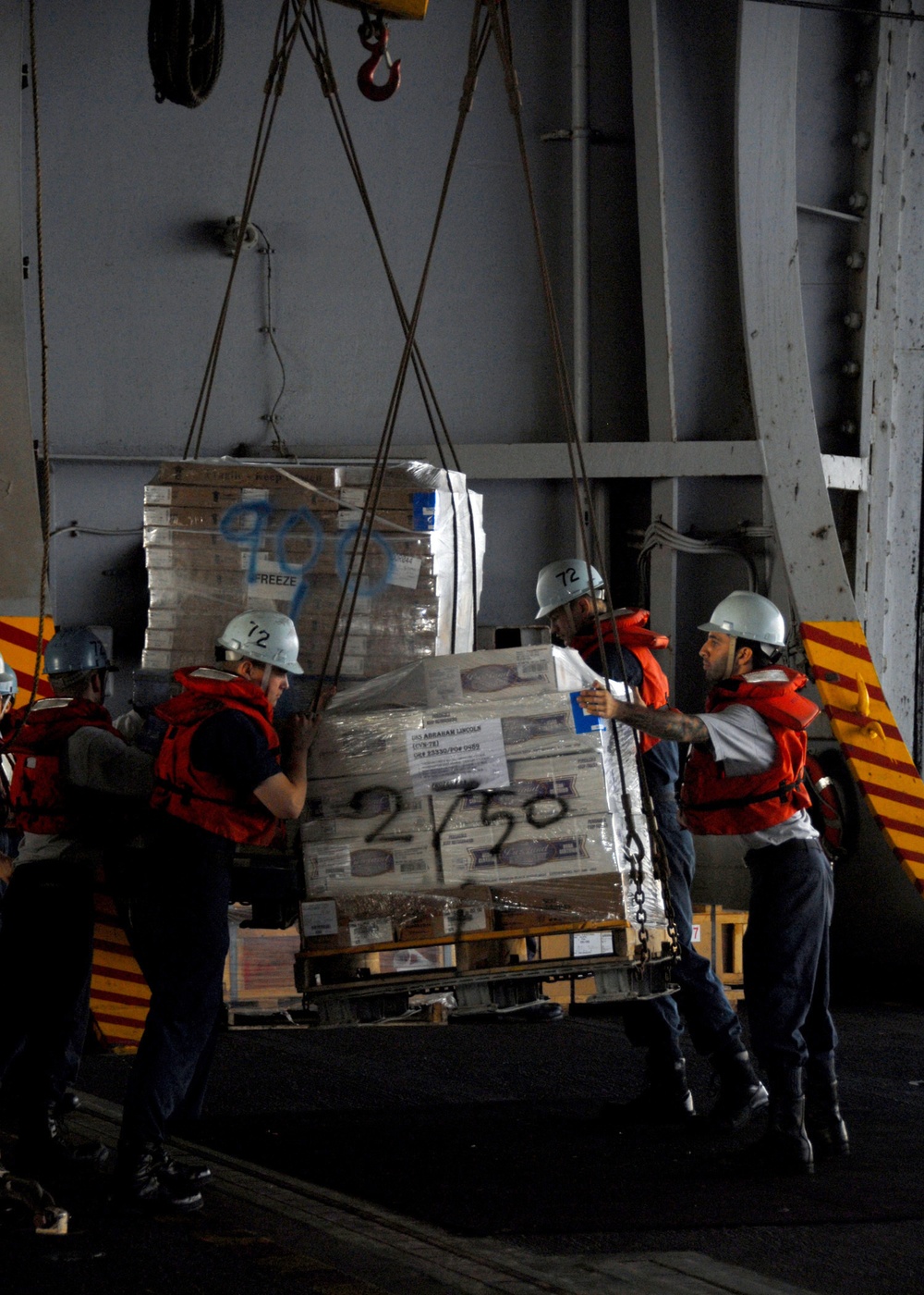 Pallets of supplies coming in to the USS Abraham Lincoln