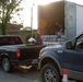 Louisiana Air National Guardsmen of the 159th Air Maintenance pass out supplies in Jeanerette, La