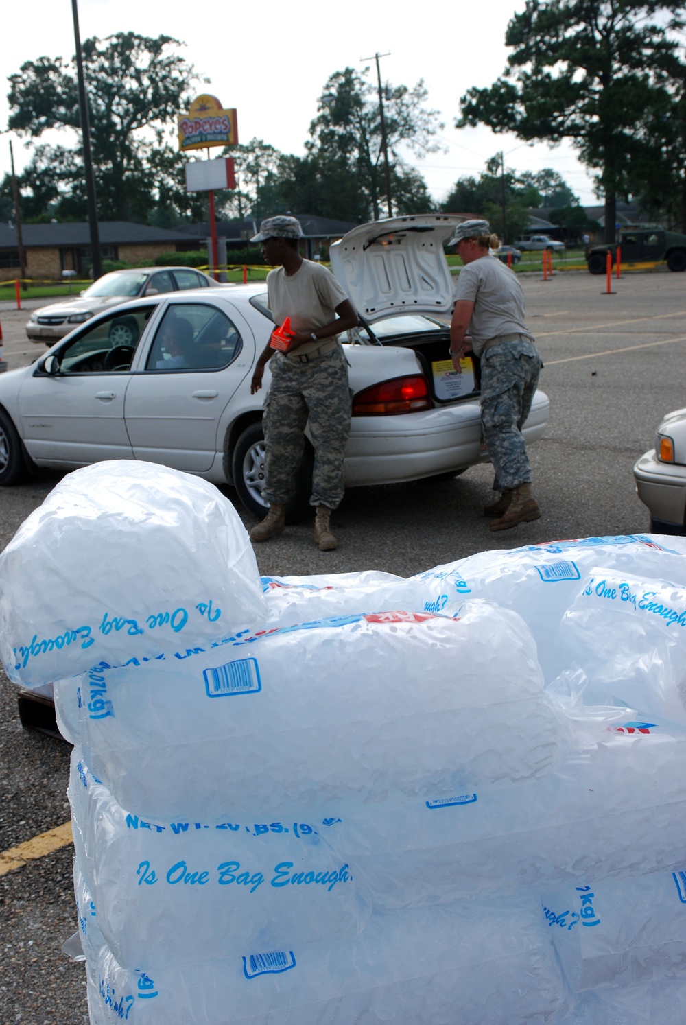 Louisiana National Guardsmen hand out supplies to residents in New Iberia, La.