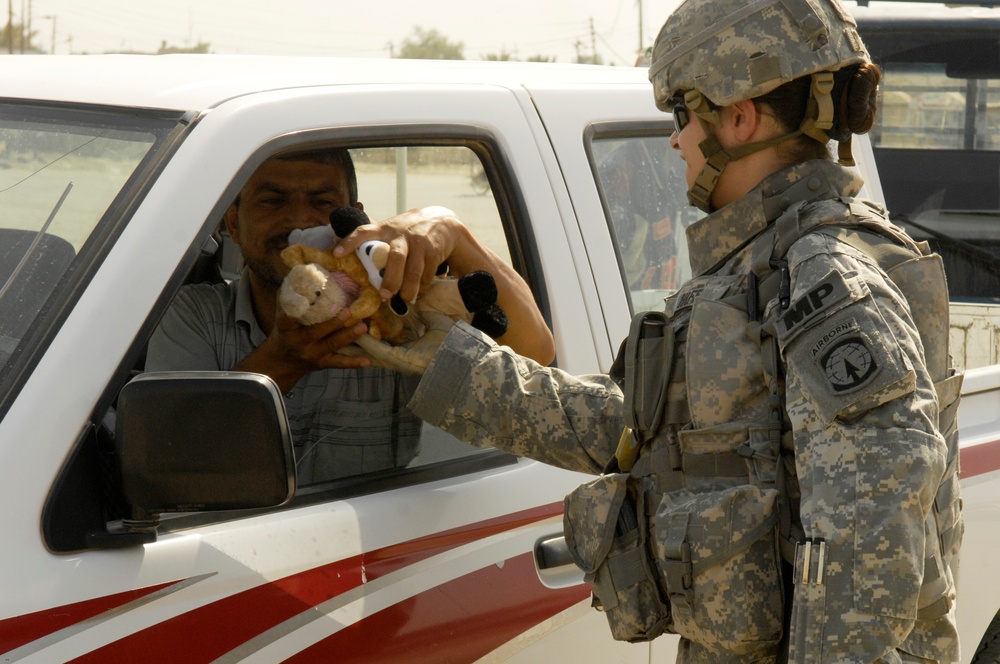 U.S. Soldiers Hand Out Stuffed Animals