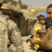 U.S. Soldiers hand out stuffed animals