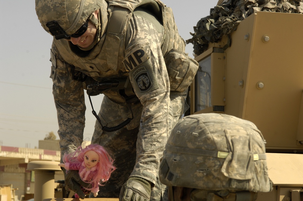 U.S. Soldiers Hand Out Stuffed Animals