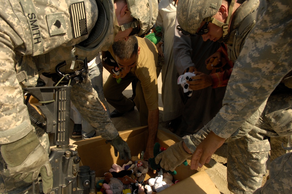 U.S. Soldiers Hand Out Stuffed Animals