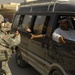 U.S. Soldiers hand out stuffed animals