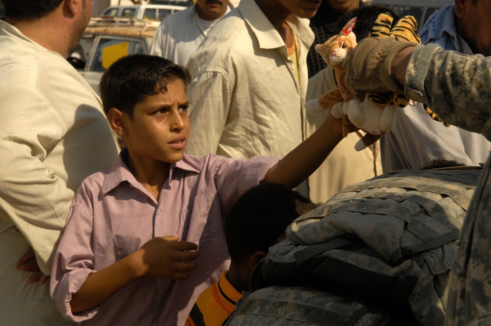 U.S. Soldiers Hand Out Stuffed Animals