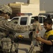 U.S. Soldiers hand out stuffed animals