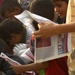 Iraqi national police hand out leaflets