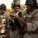 Iraqi Soldiers Hand Out Wanted Posters