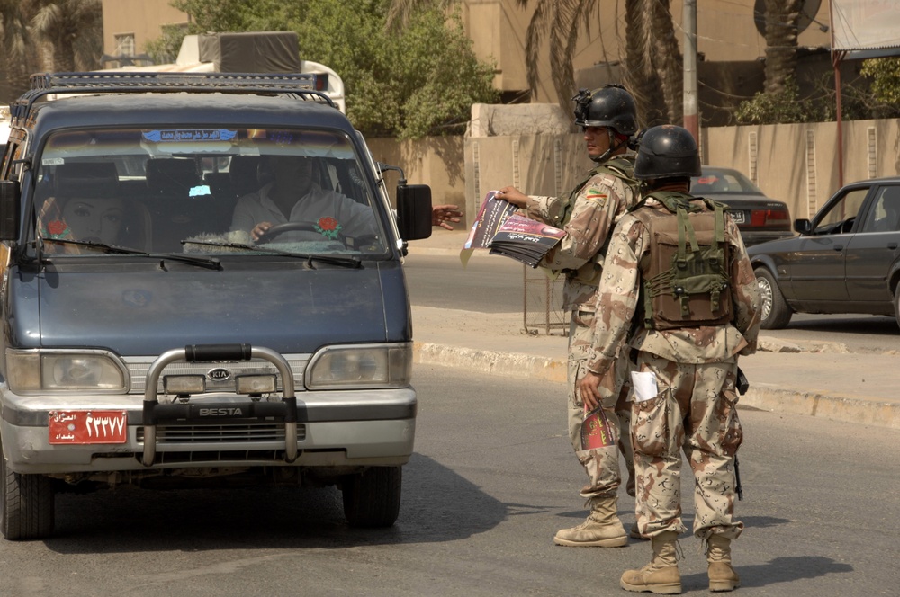 Iraqi Soldiers Hand Out Wanted Posters