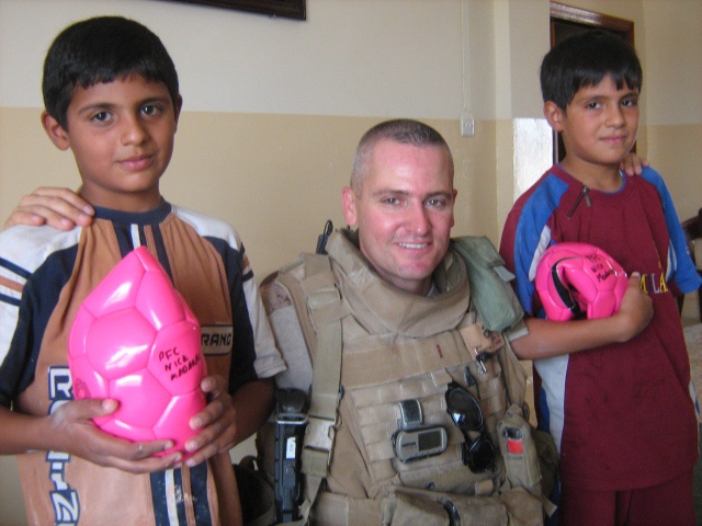 Iraqi children play soccer; Remember hero