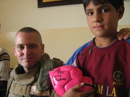 Iraqi children play soccer; Remember hero