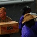 USS Kearsarge service members, Haitian citizens load hurricane relief supplies