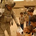U.S. Soldiers pass out soccer balls