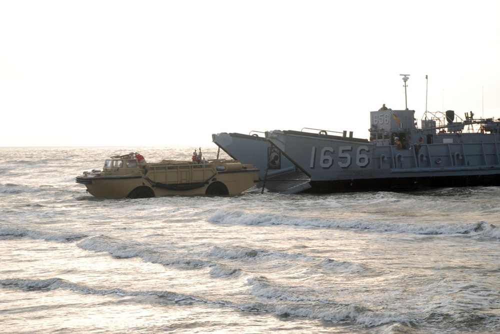 Light amphibious re-supply cargo vehicle delivers hay to stranded cows on Galveston beach
